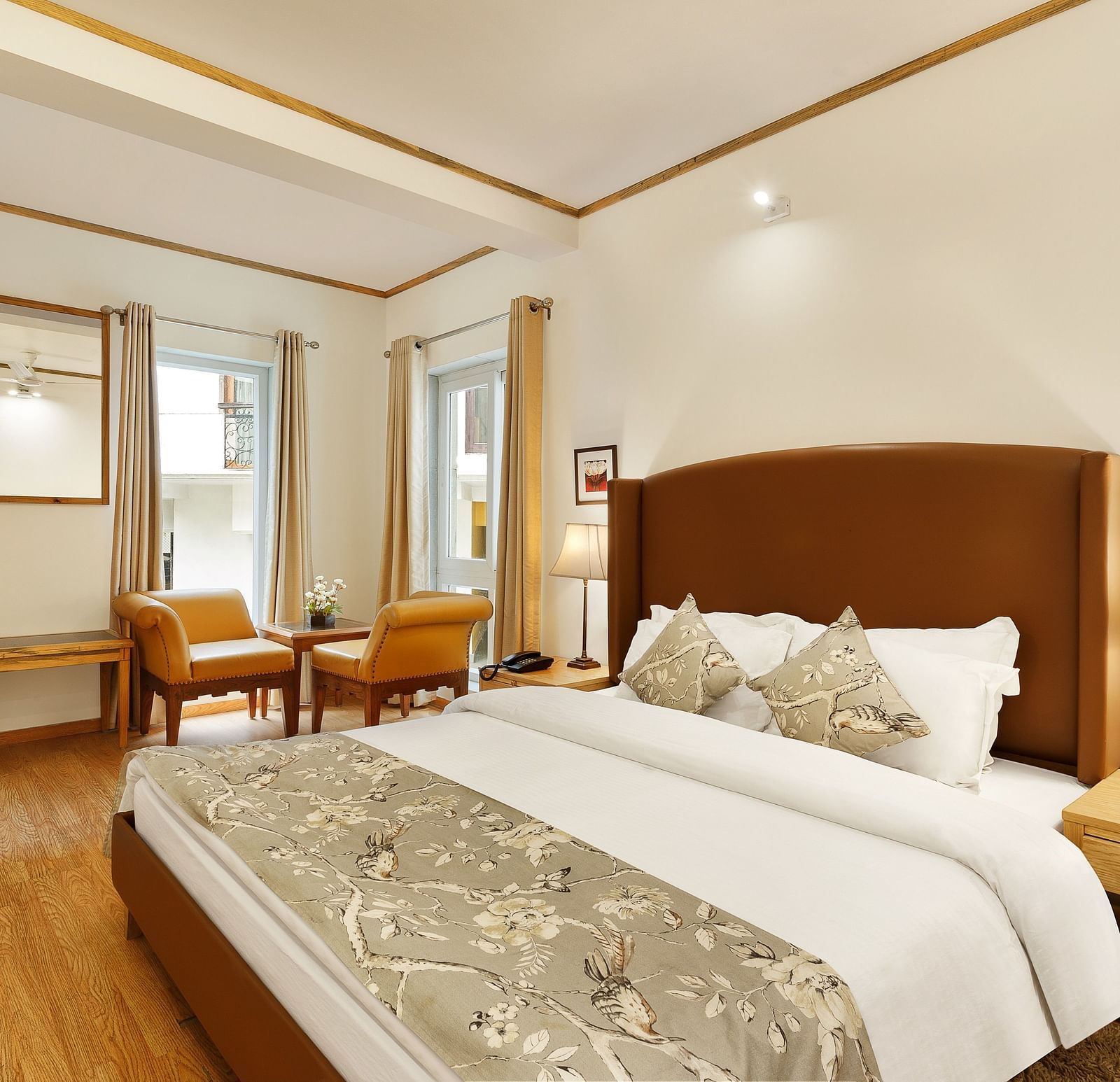 A cosy room with comfy bed chairs and a cupboard near window in Pinewood Nainital 