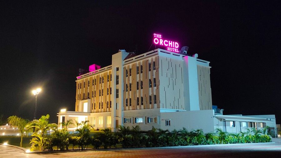 Facade image of The Orchid Hotel, Jamnagar in the night with the lights on 