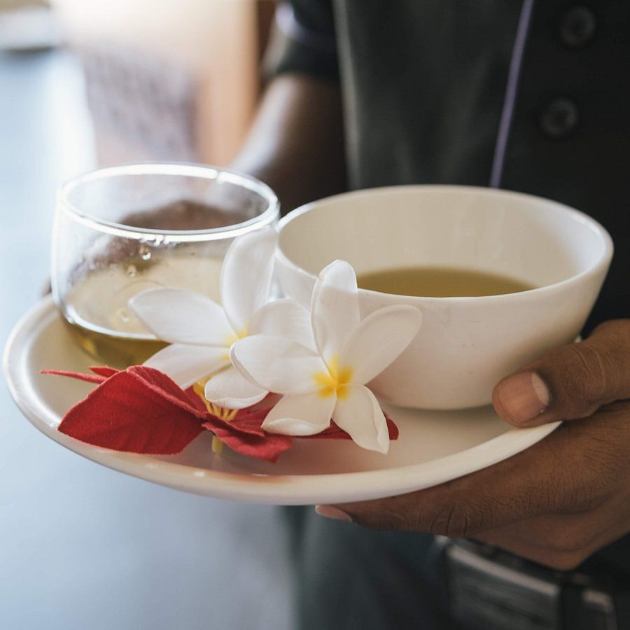man holding a cup of tea Rejuvenate- The Golden tusk