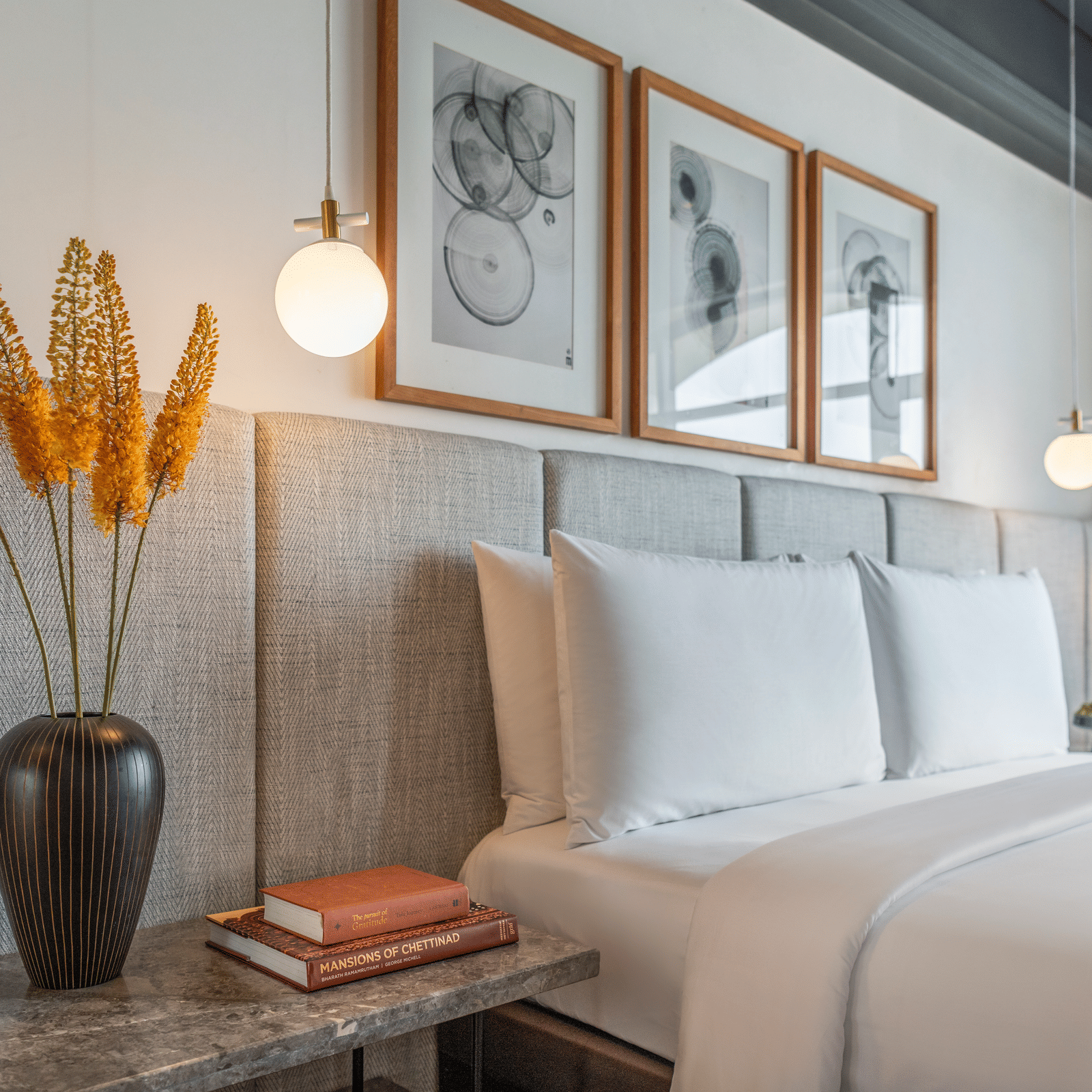 Bedroom with bed, framed artwork, and bedside lamp at The Raintree, St. Mary’s Road.