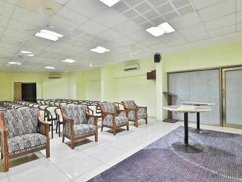 A conference hall with chairs facing the stage at VITS Select, Bharuch. One of the best wedding venues in Bharuch, Gujarat.