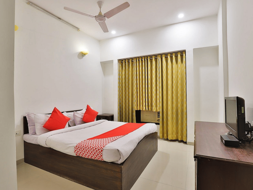 Superior room with a large bed facing the TV at VITS Select, Bharuch.