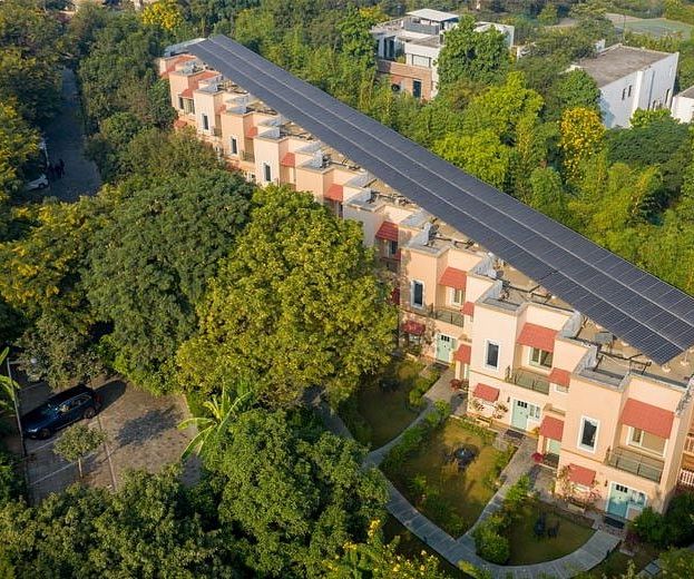 Aerial view of buildings surrounded by trees within the Karma Chalets property.