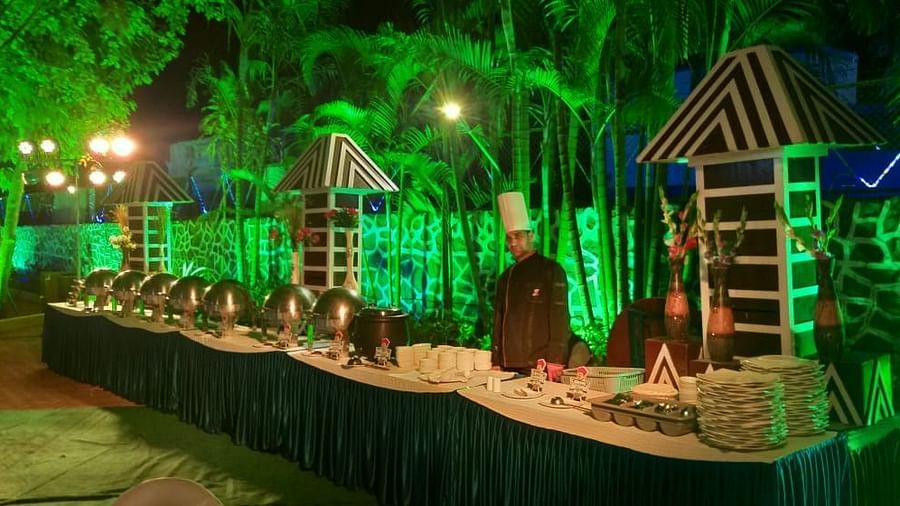 the buffet spread outside at the lawn with chefs standing behind it - Zara's Resort 