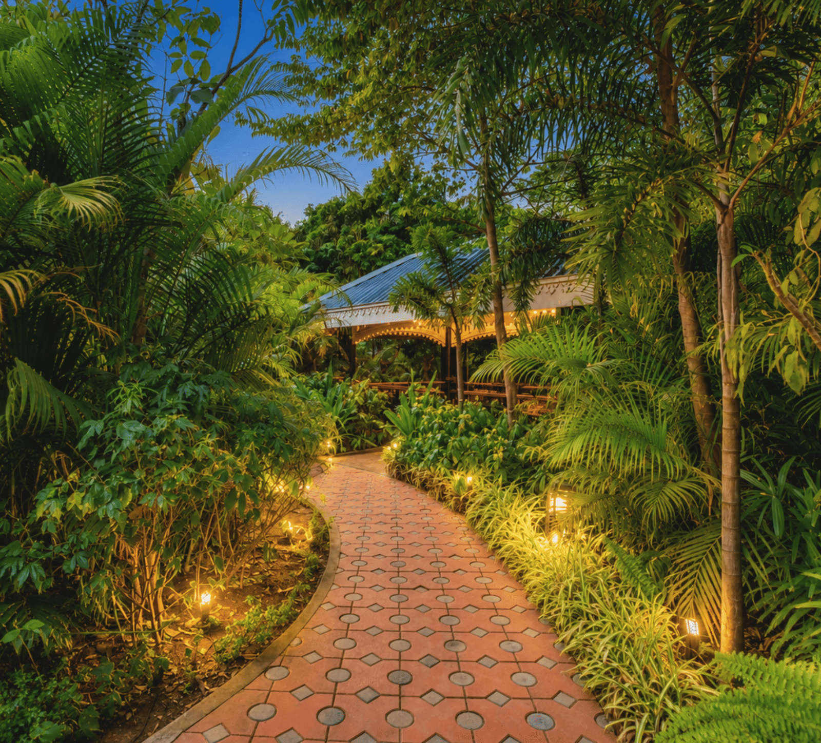 Illuminated pathway through the Oxygen Garden at Mayfair Oasis Resort, Jharsuguda