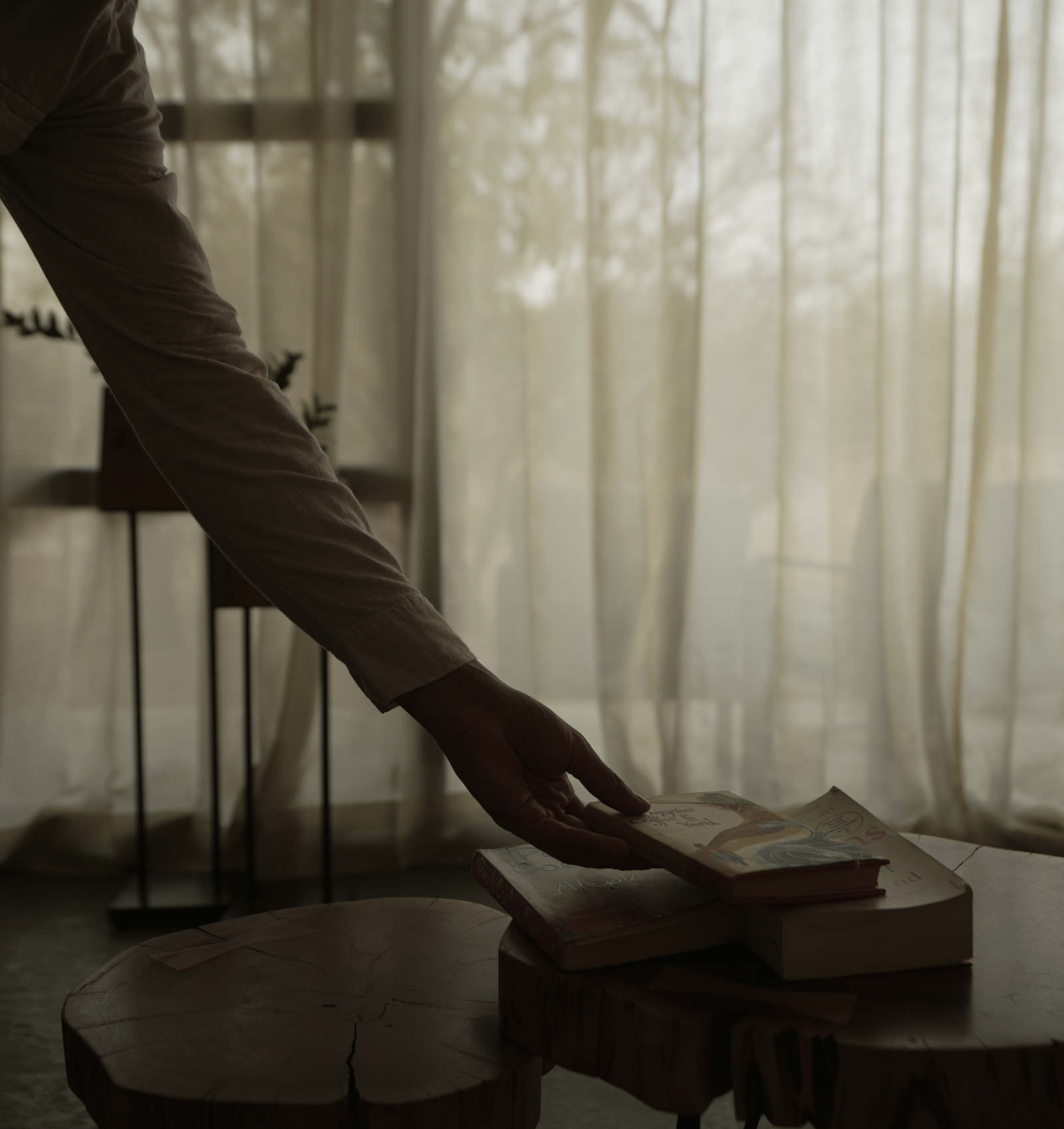 An image of a person hand lifting a book