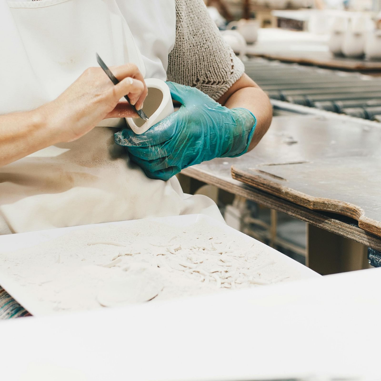 A person shaping a clay article