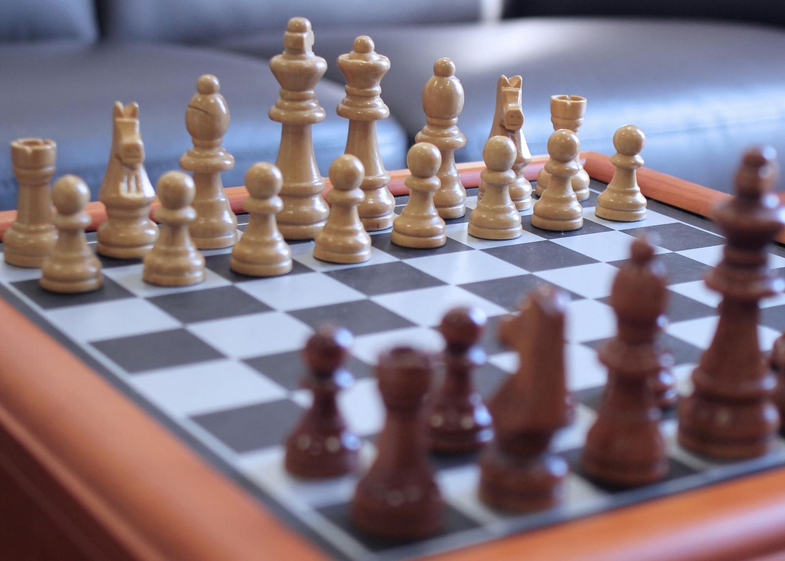 Chessboard set with pieces arranged on a wooden table