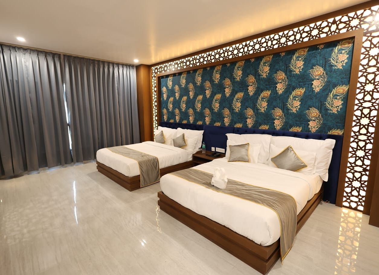An interior shot of a room with twin beds and a textured accent wall - Bamboo Saa Mulberry Resort, Pushkar