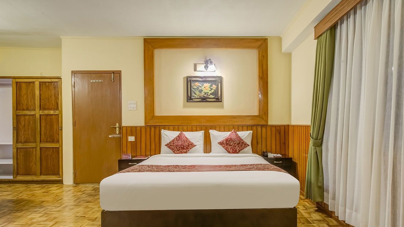 Image of a room with bed and large windows at Summit Tashi Ghang Heritage Resort, Pelling