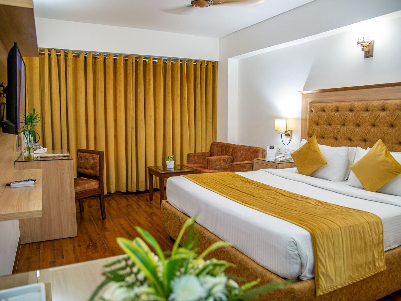 A side view of a room with a bed and TV | Sun Park Hotel & Banquet, Chandigarh - Zirakpur