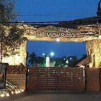 Facade of GK Hill View Resort decorated with decorative lights during the dusk.