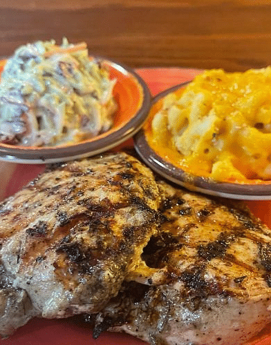 a delicious serving of grilled chicken served with a bowl of mac n cheese along with coleslaw at Tapoco Tavern - Historic Tapoco Lodge