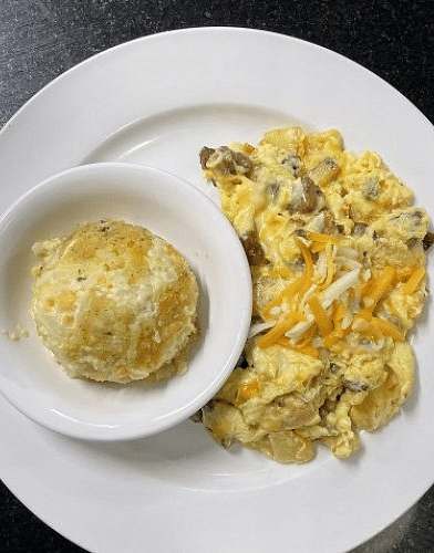 a serving of delicious and soft scrambled eggs served with a bun - Historic Tapoco Lodge