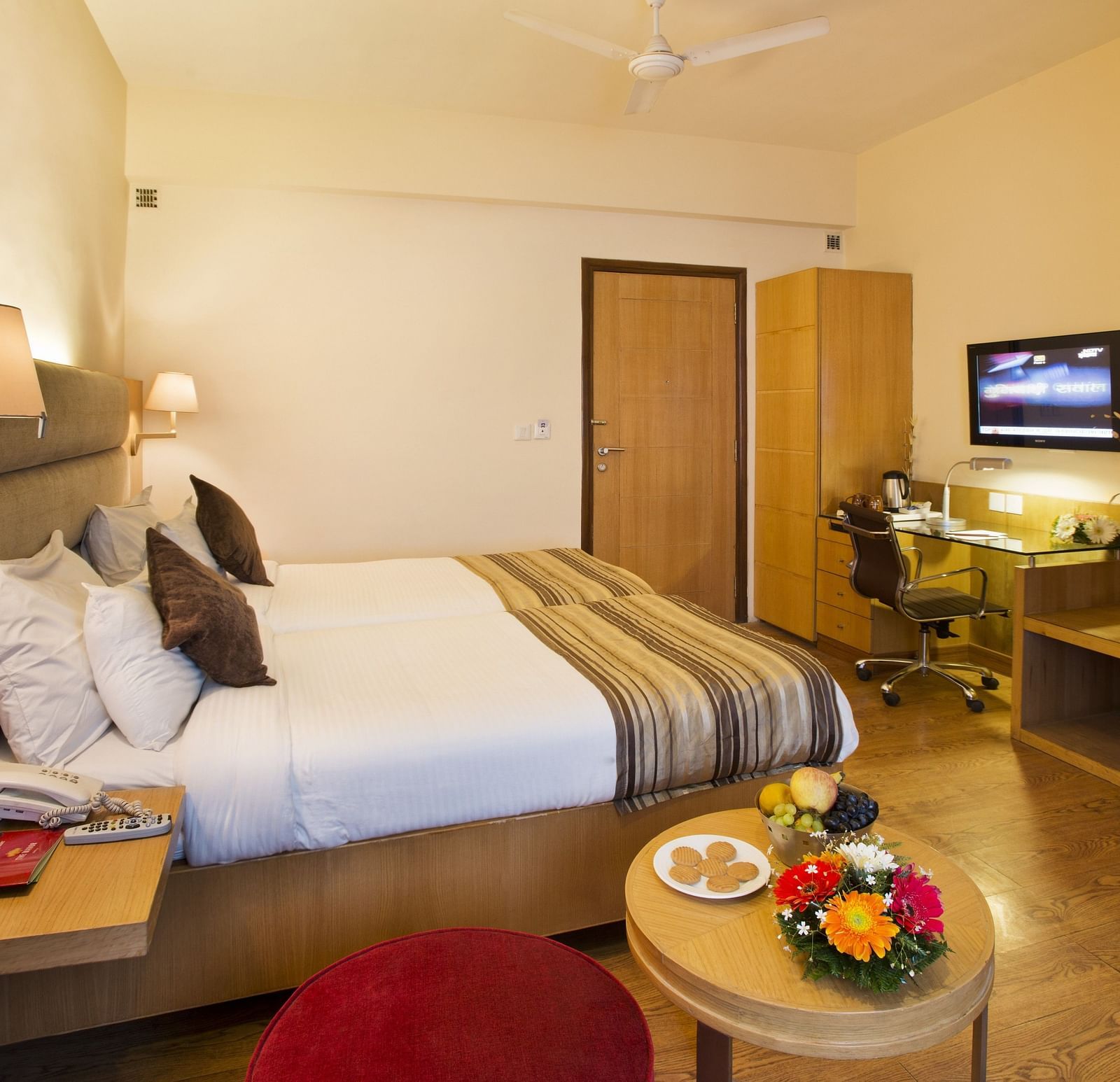 an image of a side view of the deluxe bedroom with a television at The Manor, Bareilly