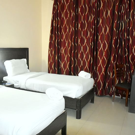 A sideview of twin beds in Deluxe Rooom | Hotel City Inn, Varanasi