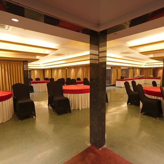 Wide view of the round tables and chairs at Moti Mahal, our in-house banquet hall at The Garden Ananta Elite, Rajkot 2