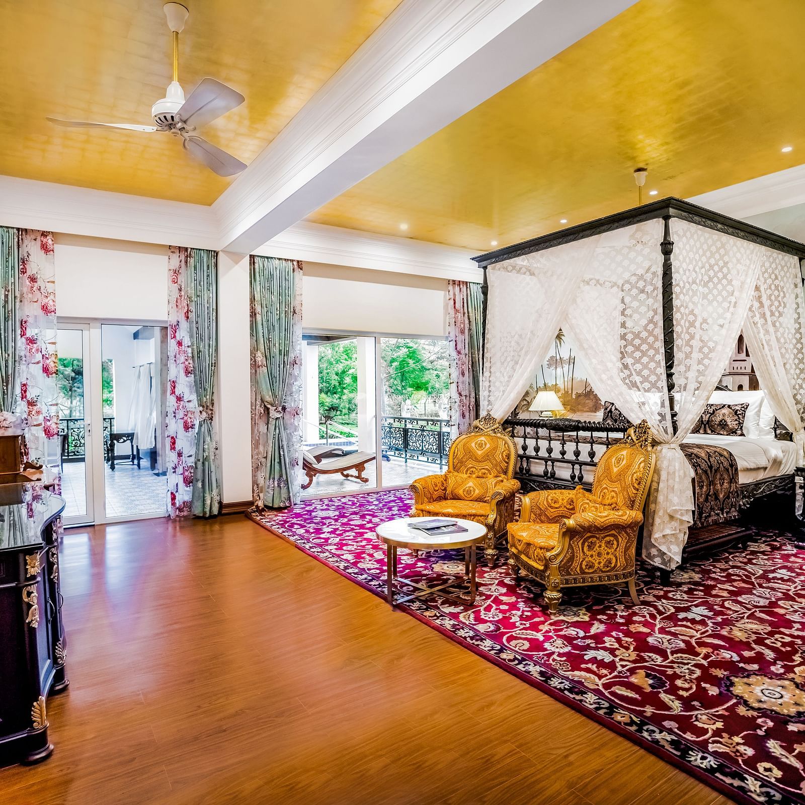 two chairs kept in front of a king size facing a wooden cabinet - Mayfair Tea Resort, Siliguri 