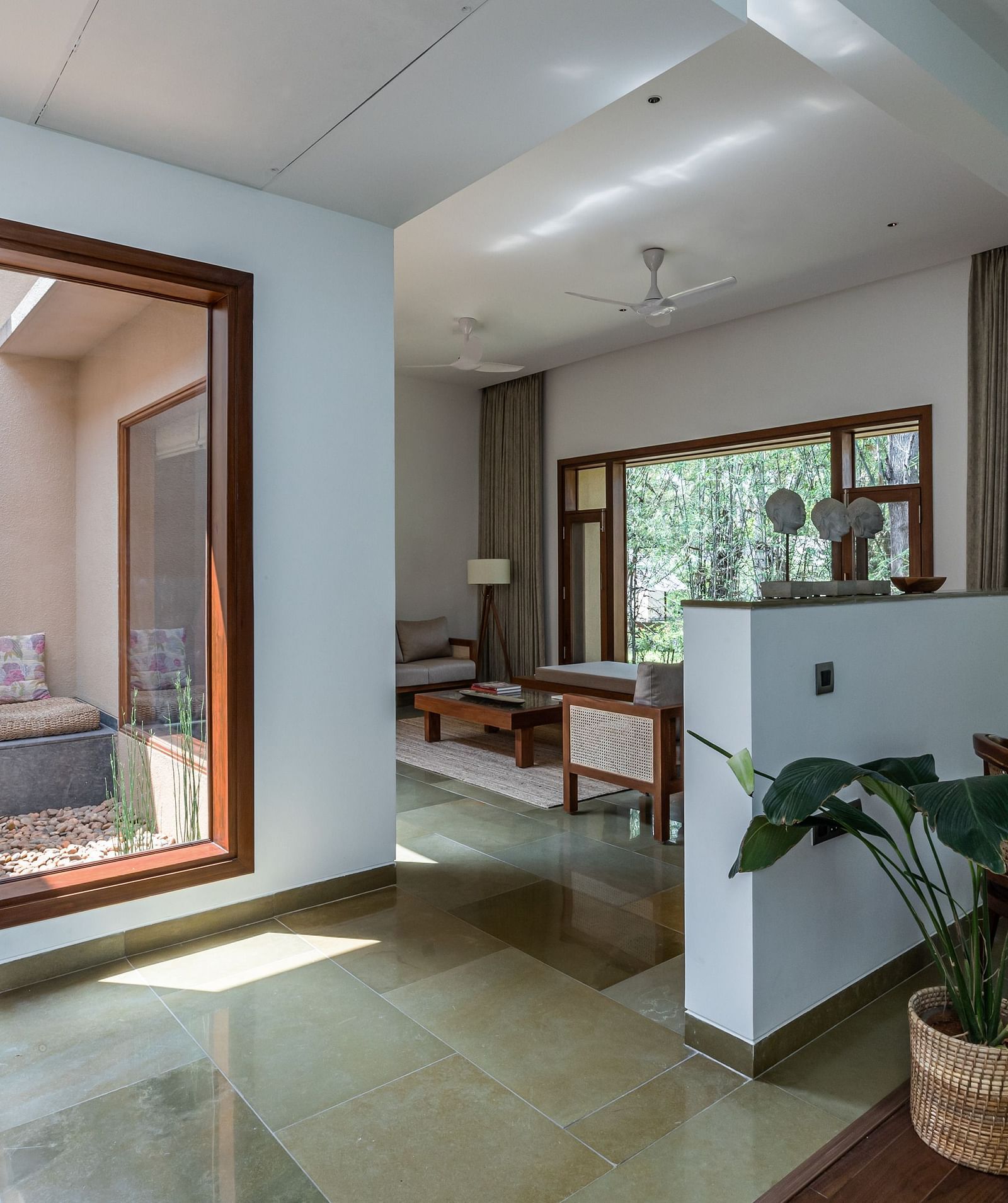 Living room with a sliding glass door, indoor plants, modern design, bright interior - Shreyas Retreat