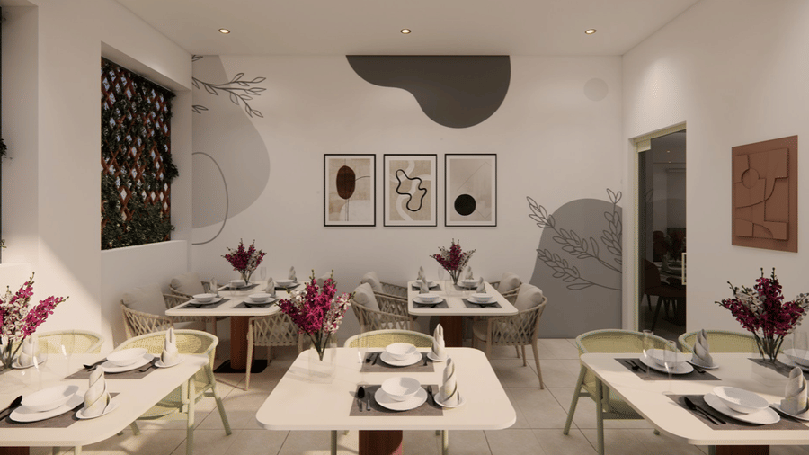 Dining tables set with tableware and wall art at Kensho Bistro in Hotel Kyzen Shamshabad.