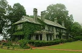 Facade of an old building covered with greenery
