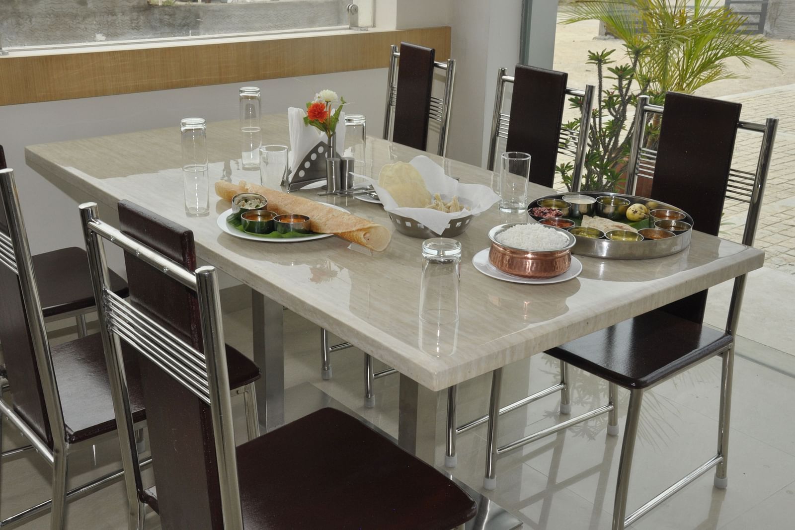 interior dining setting of a restaurant at Hotel Alps Residency, Krishnagiri