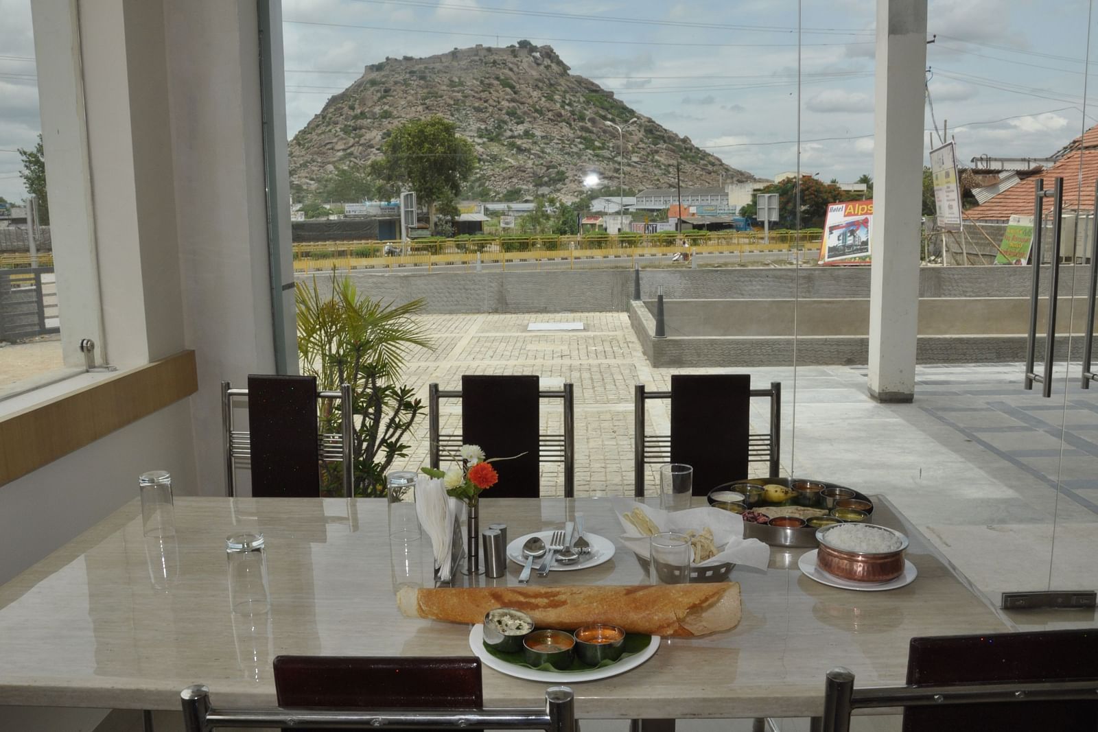 interior dining setting of a restaurant at Hotel Alps Residency, Krishnagiri