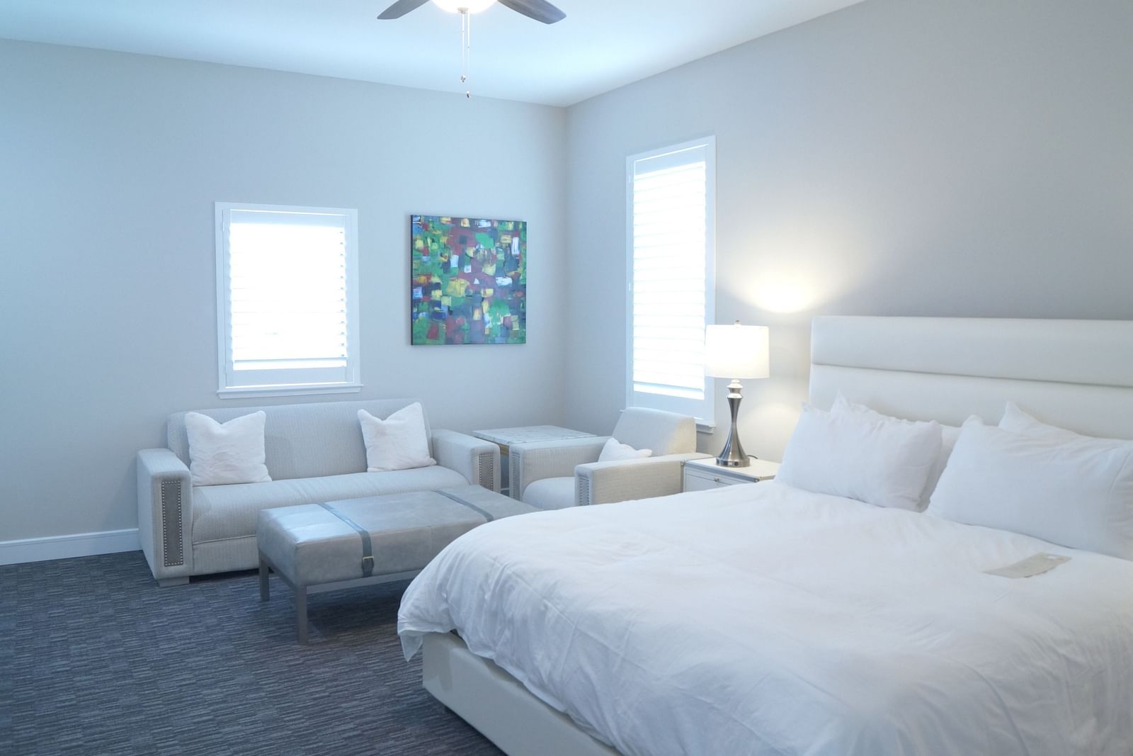 A stylish bedroom featuring a large bed, soft lighting, and minimalist furniture, designed for a comfortable stay - The Grand Hotel & Ballroom, McKinney