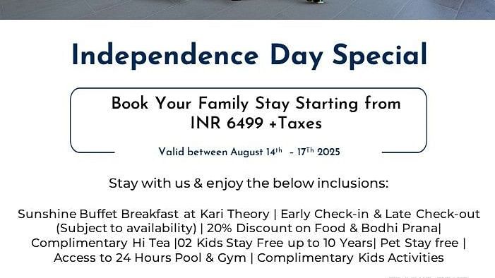 Creative family lifestyle photography of a father walking hand-in-hand with two young children through the hotel lobby, with one child carrying a red cape, showcasing the Independence Day Special family-friendly atmosphere at Radisson Bengaluru.