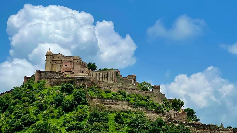 A wide view of a fort surrounded by greenery on a cloudy day
