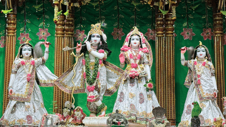 Stock illustration depicting Radha and Krishna idols decorated with traditional clothing and ornaments.