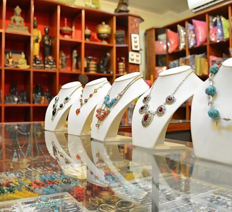 A jewelry store display featuring necklaces on bust stands