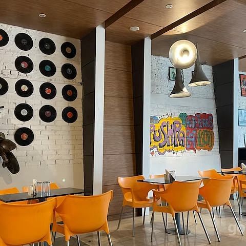  Another angle of the dining area highlighting the vinyl records wall and scooter art piece.