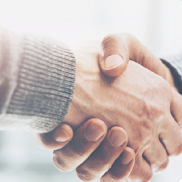 a closeup image of two people shaking hands