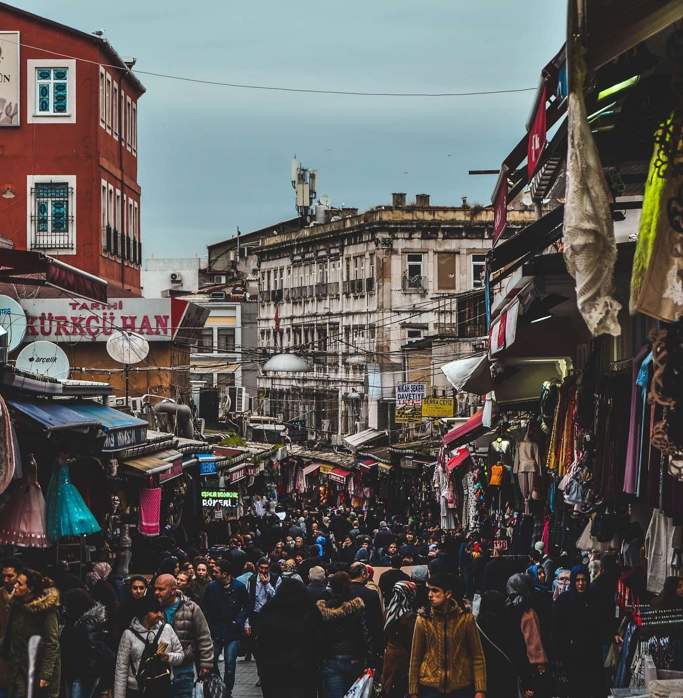 A view of a market with crowds moving along.