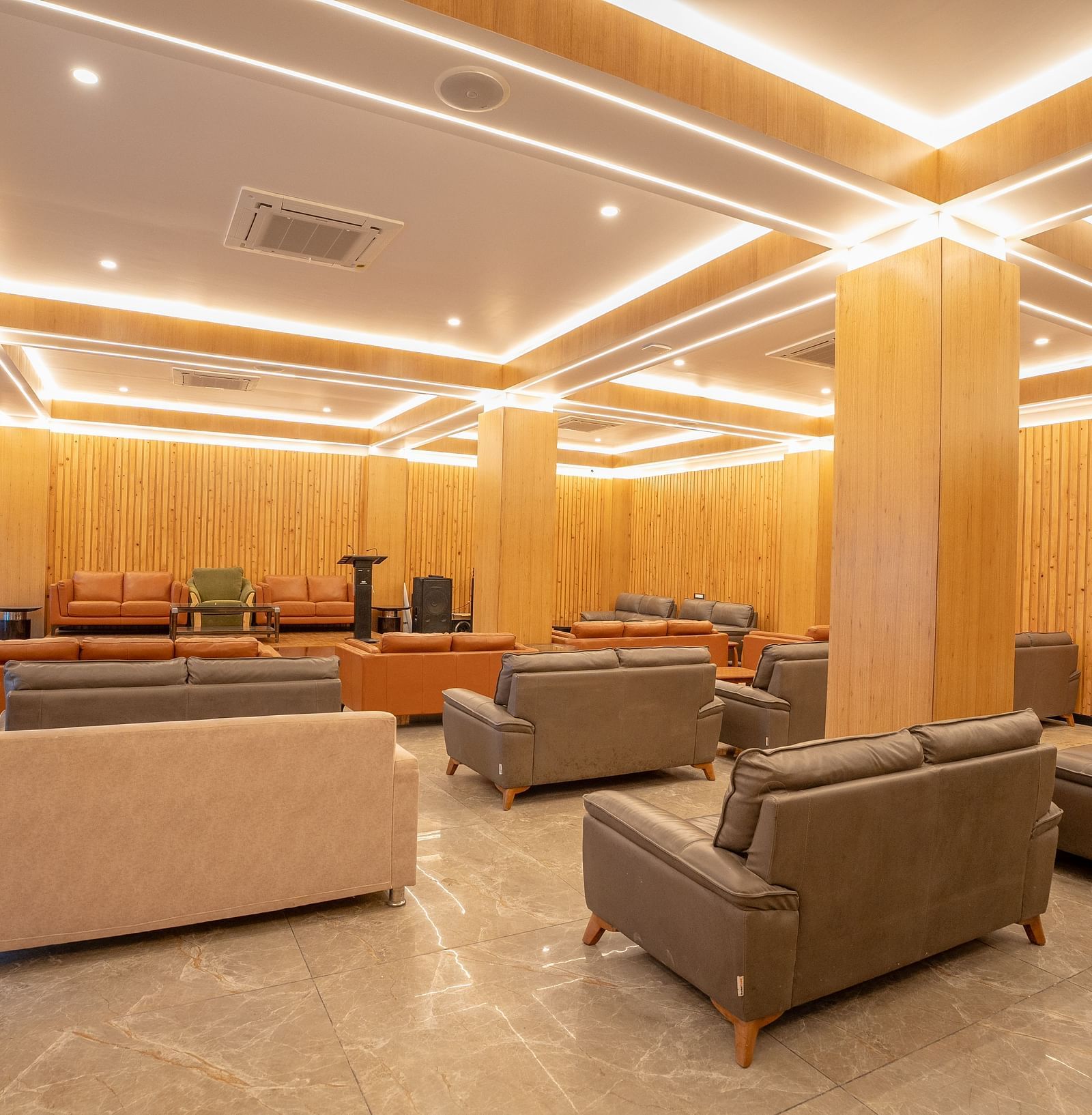 event hall with brown sofas at Summit Grand Resort & Spa