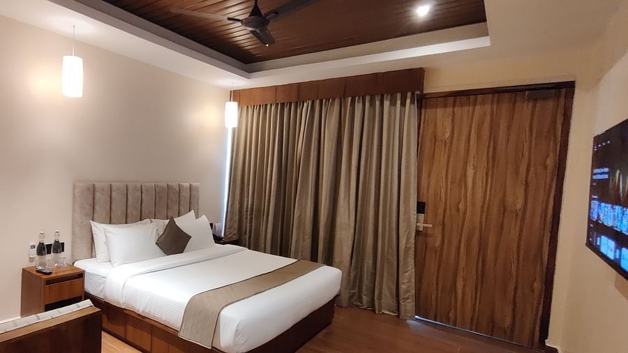 Side view of the room showcasing the veranda with sliding glass doors and greenery