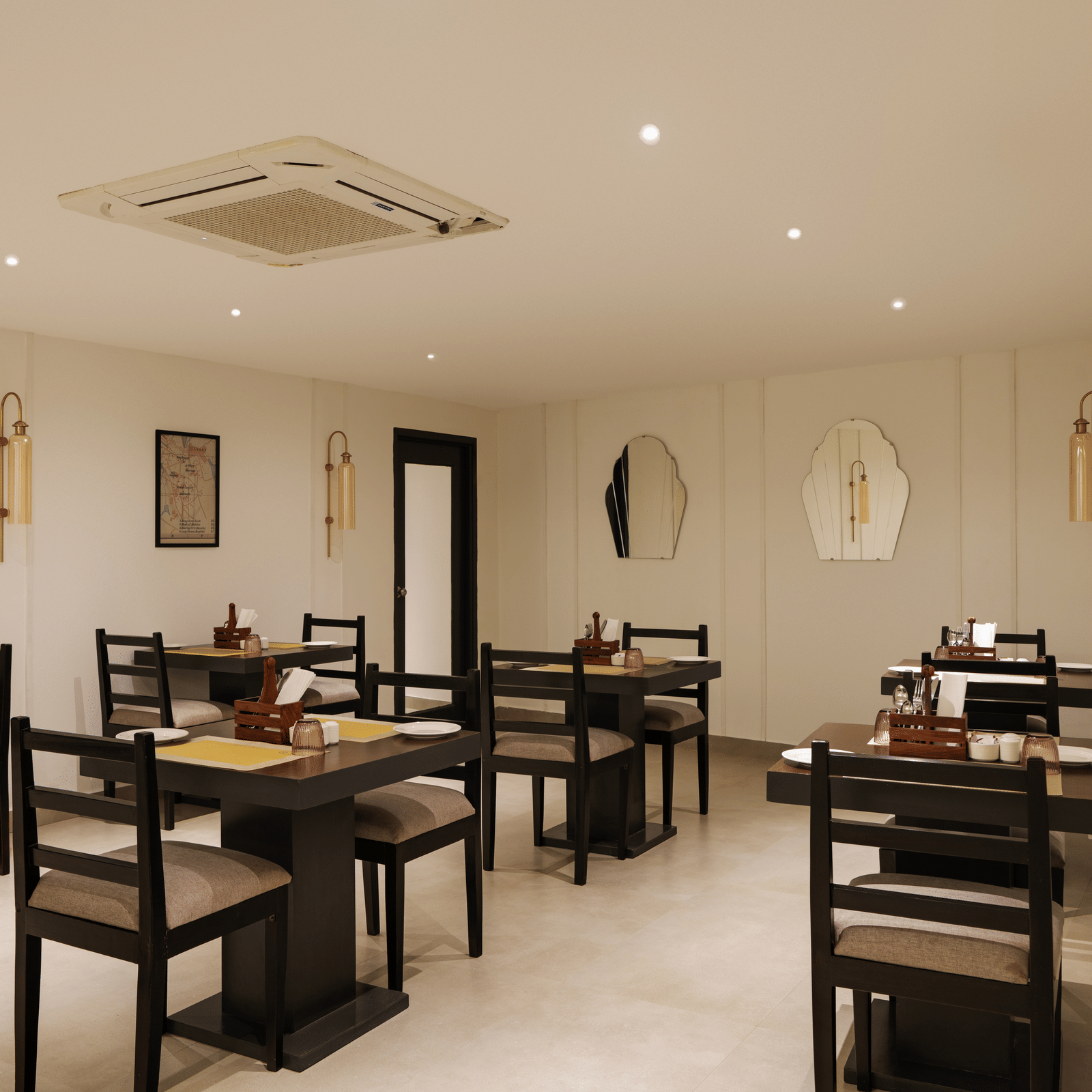 Restaurant at Shilton Suites, Bengaluru, with tables, chairs, and elegant interior furnishings.