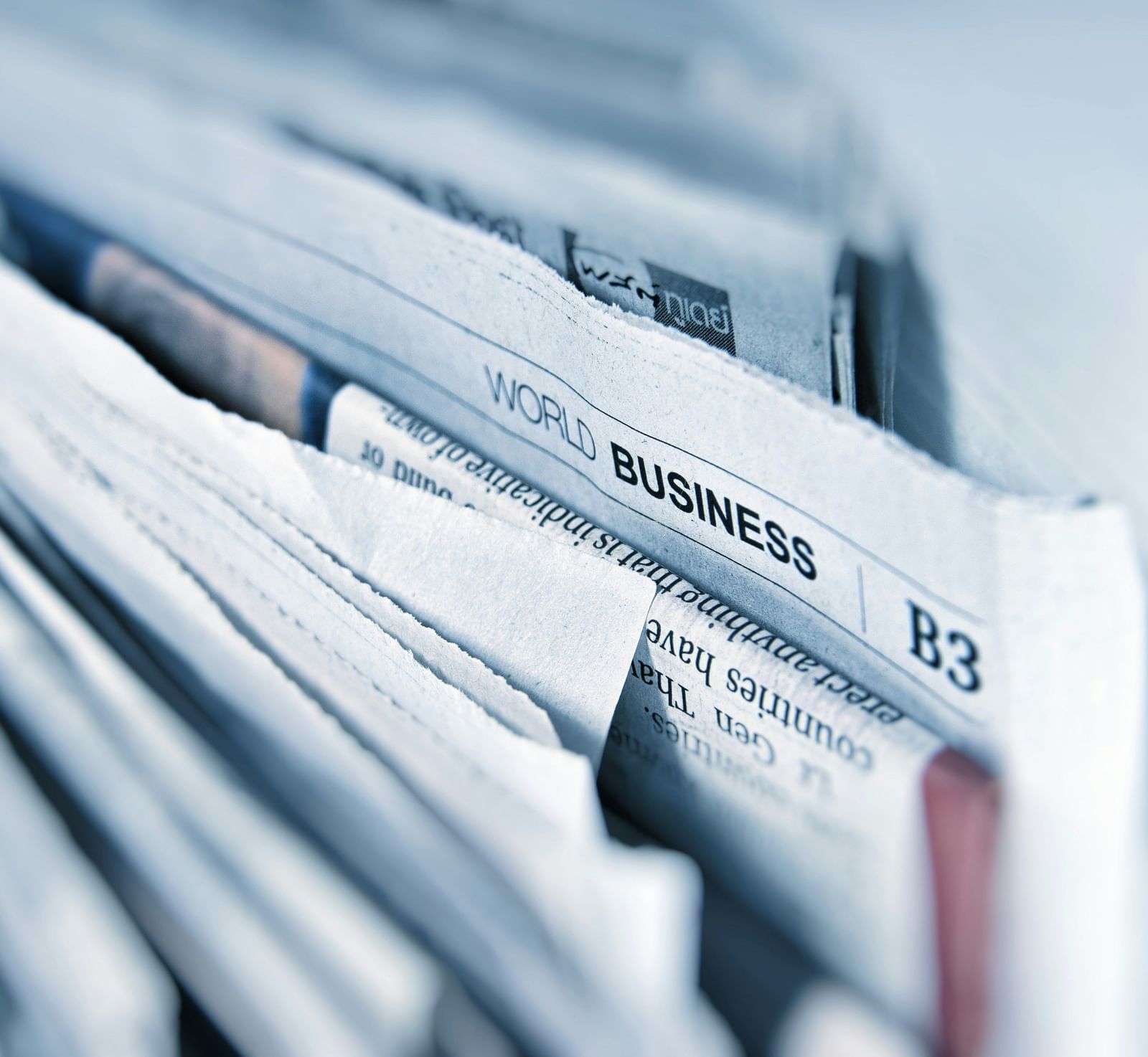 A close-up shot of the edge of a newspaper bundle.