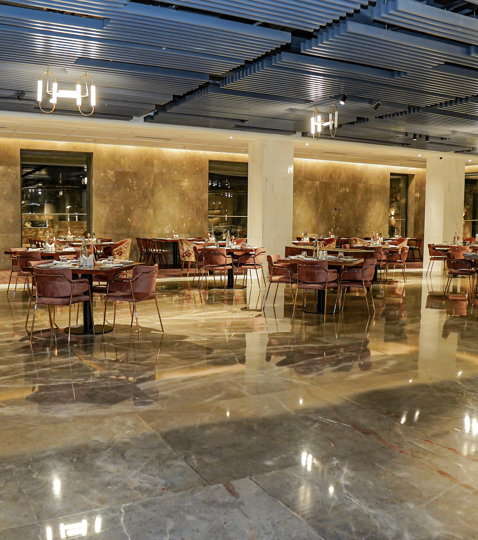 The stylishly appointed, low-lit restaurant with comfortable velvet chairs and marble walls at Pushkara Resort & Spa.