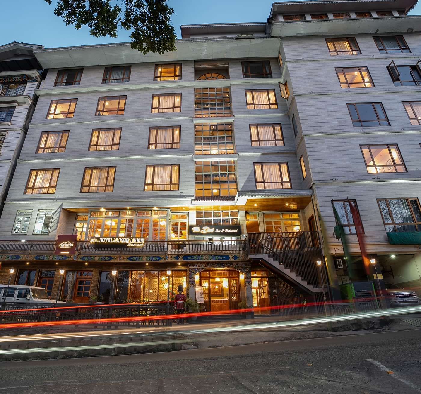 Facade image of Summit Alpine Abode Hotel with the building illuminated by lights