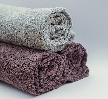 Three neatly rolled towels