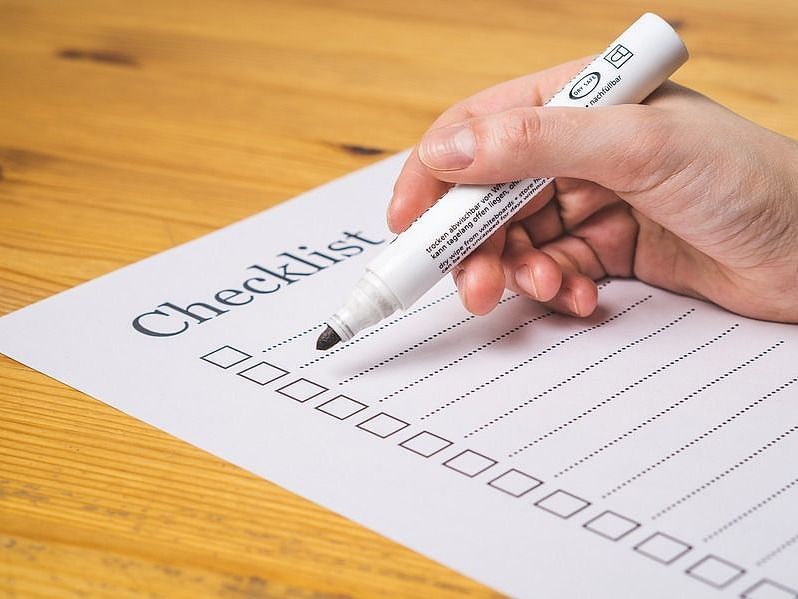 An image of a checklist and a hand with marker