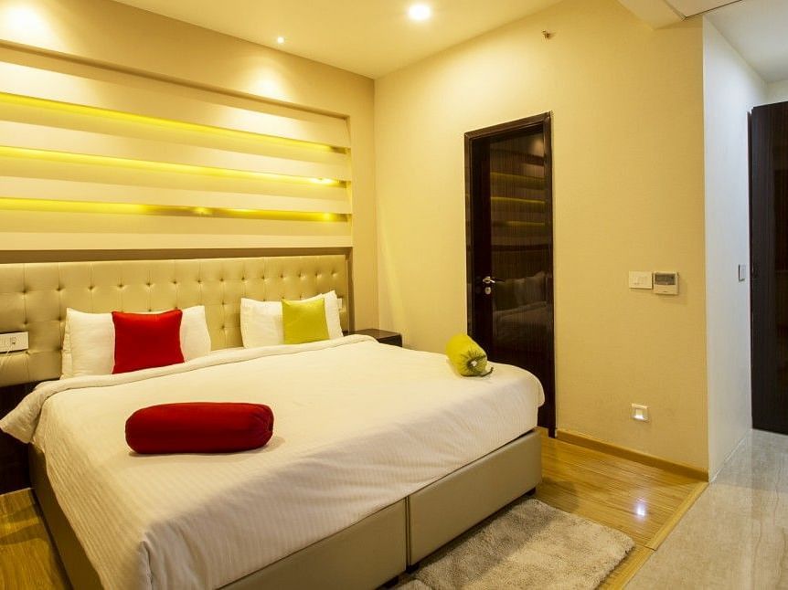 The room of the suite with bed and pillows and blosters on in at Art Boutique Hotel, Hyderabad