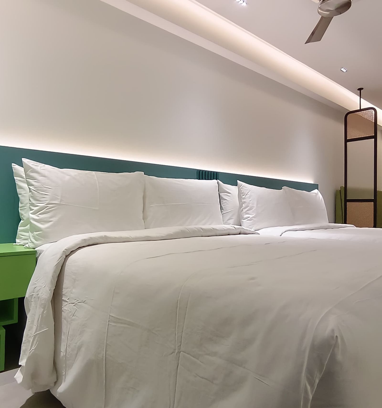 Vibrant bedroom with colourful interiors and a neatly made large bed