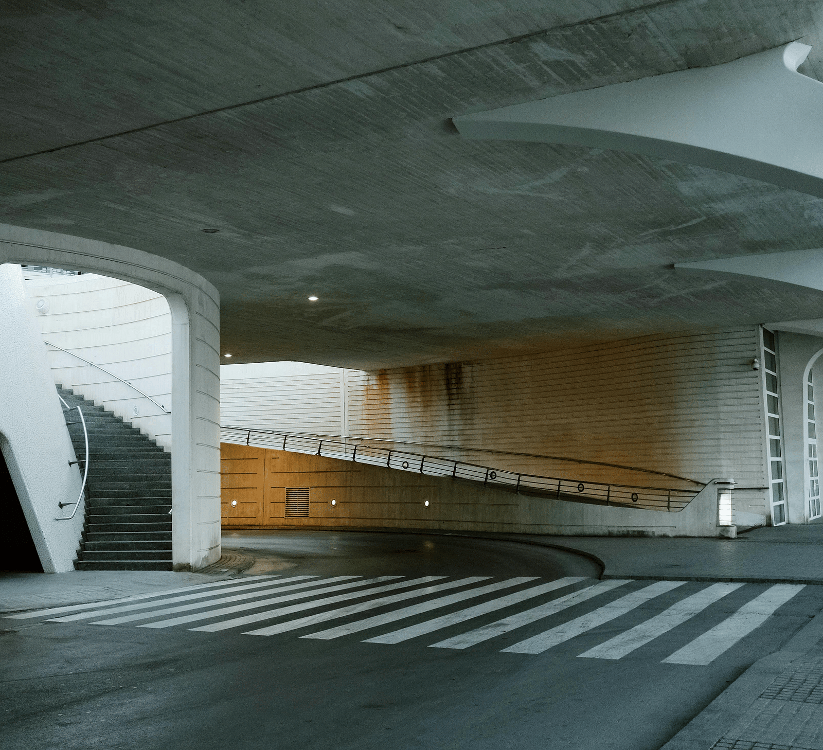 An image of a parking area with a flight of stairs going to the upper level