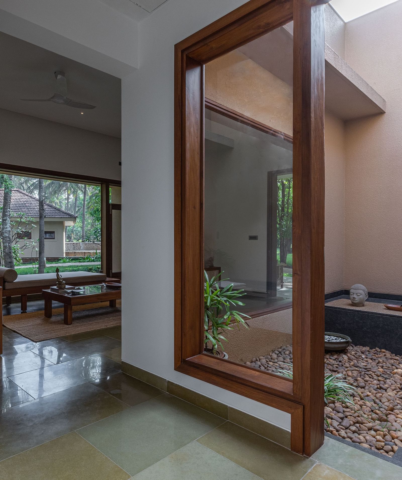 A room with large glass doors leading to a patio with a bathtub, modern interior design - Shreyas Retreat