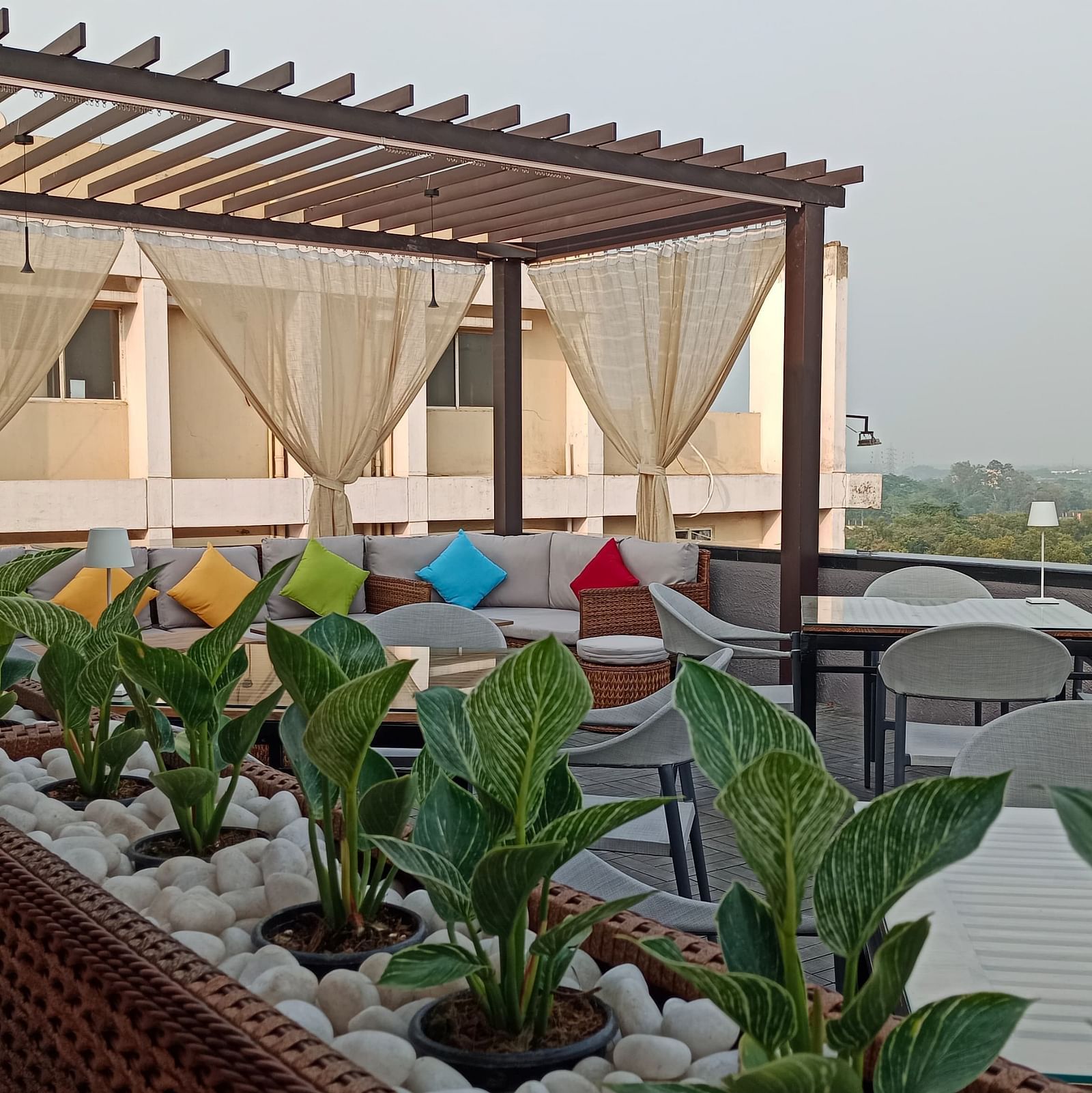 Nasha The Rooftop dining area at Wonder Country Club and Resort, Kharagpur featuring elegant seating, open-sky ambience, and side-lined greenery