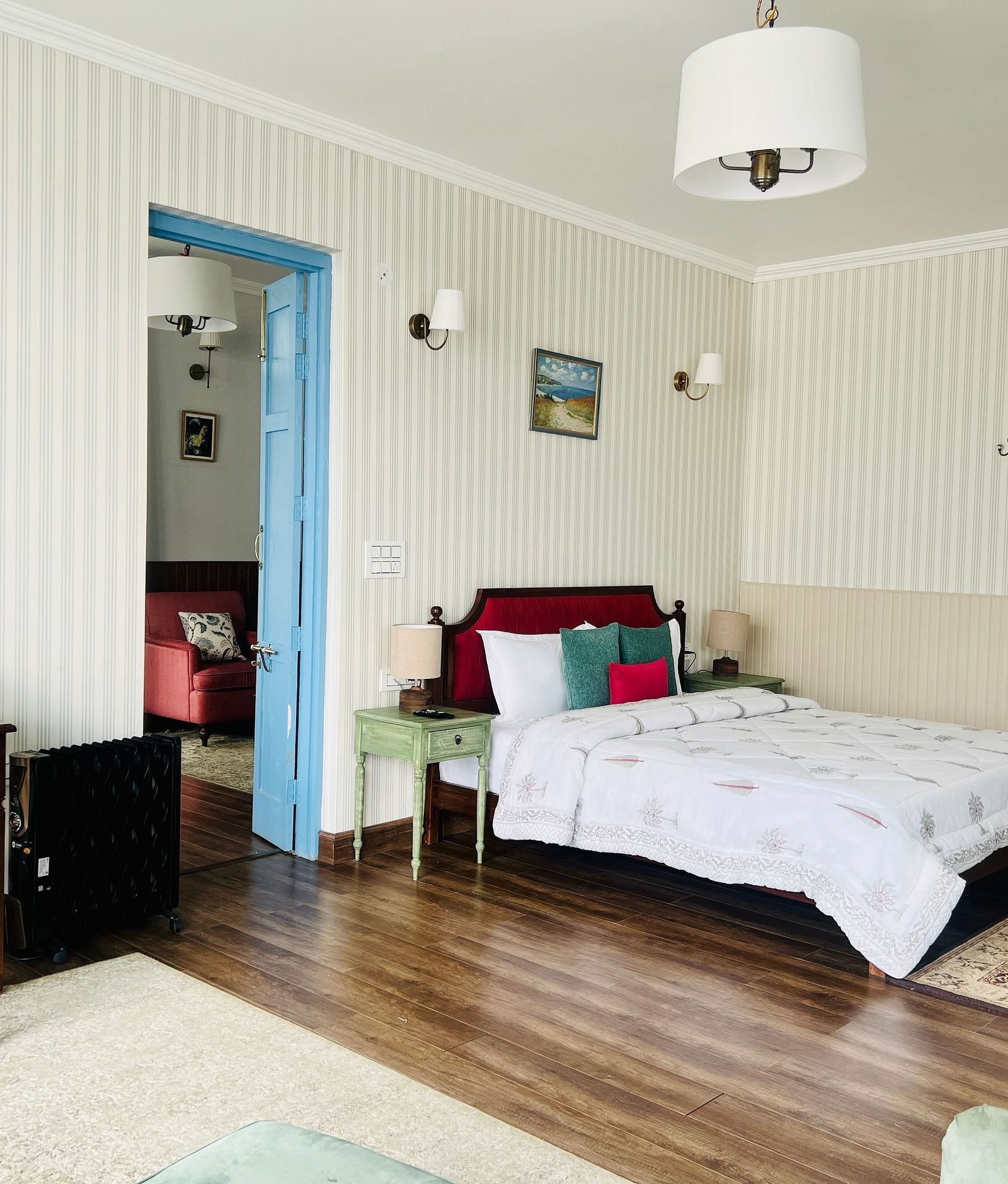 An image of a suite with bed, a table and chair, and bathroom attached | Faraway Cottages, Auli