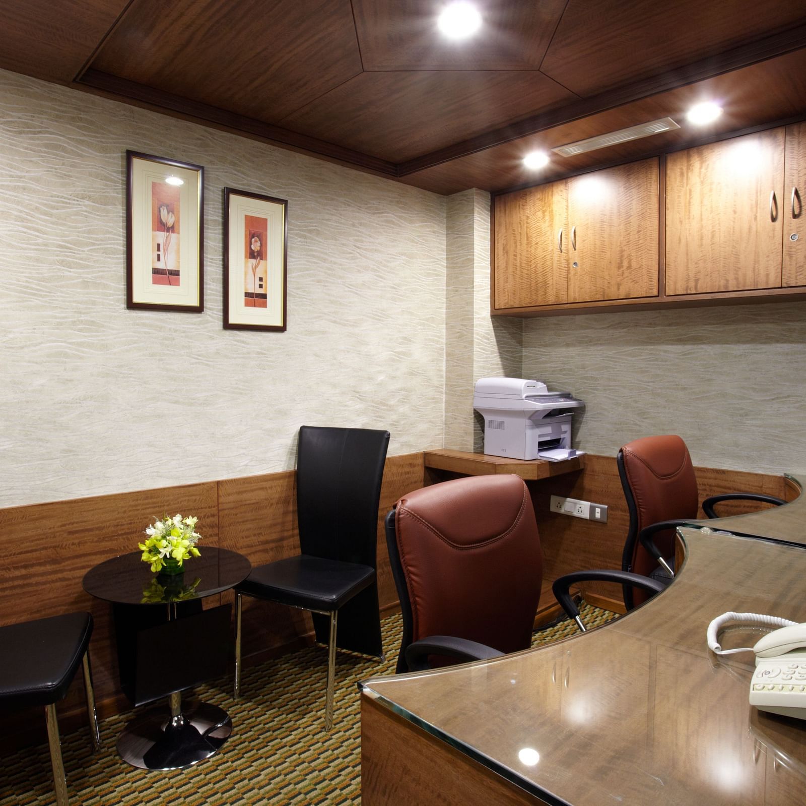 Reception table with chairs, table and monitor at The President Hotel Jayanagar, Bangalore 